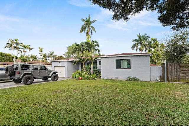 13701 NE 1st Ave, Miami, FL 33161 - ranch-style home featuring concrete driveway, crawl space, fence, a front lawn, and stucco siding
