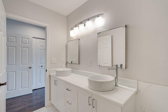 bathroom featuring a sink and double vanity