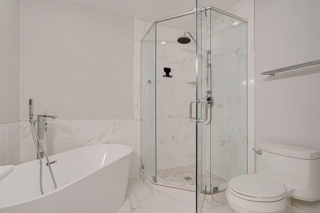 full bathroom featuring a freestanding bath, marble finish floor, a shower stall, and toilet