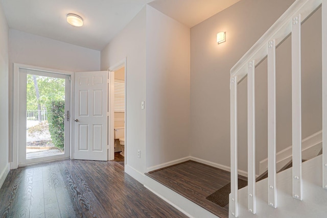 entryway with baseboards and wood finished floors