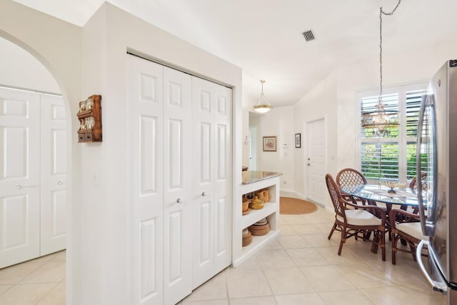 dining area featuring visible vents, baseboards, and light tile patterned floors