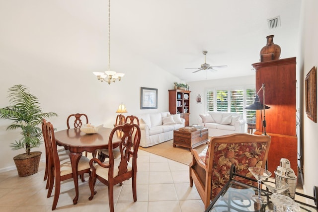 dining space with light tile patterned floors, visible vents, vaulted ceiling, and ceiling fan with notable chandelier