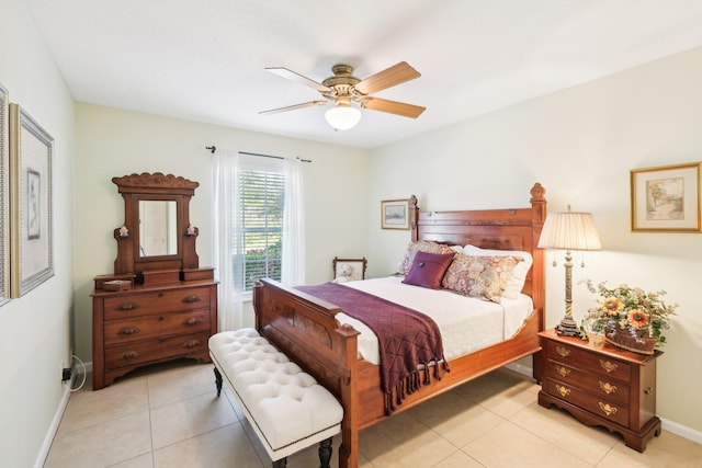 bedroom featuring ceiling fan, light tile patterned flooring, and baseboards