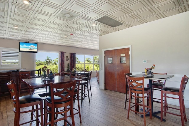 dining space with an ornate ceiling and wood finished floors