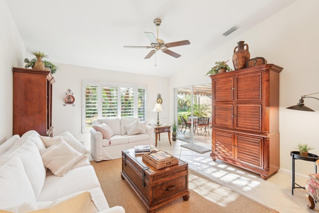 living room featuring a healthy amount of sunlight, light tile patterned floors, visible vents, and vaulted ceiling