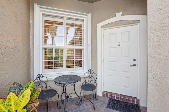 entrance to property with stucco siding