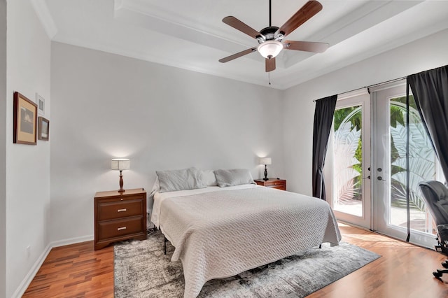 bedroom with access to outside, french doors, multiple windows, and light wood-style floors