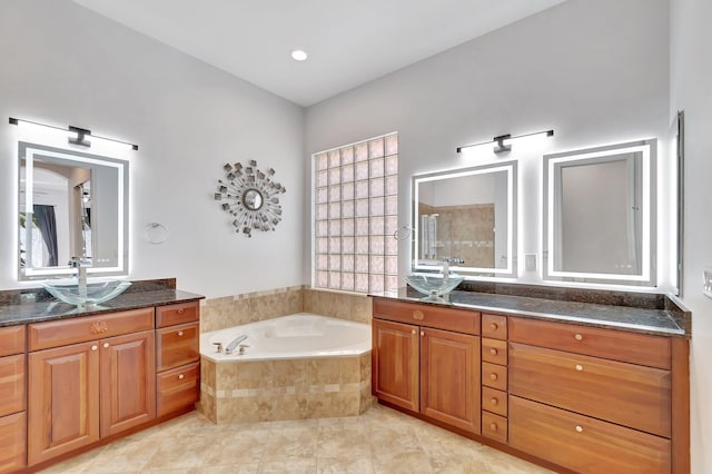 bathroom with two vanities, a sink, tiled shower, a bath, and tile patterned floors