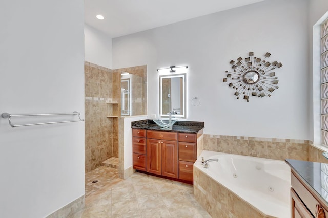 bathroom featuring a whirlpool tub, tile patterned floors, walk in shower, and vanity