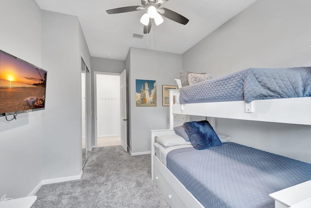 carpeted bedroom featuring ceiling fan, visible vents, and baseboards