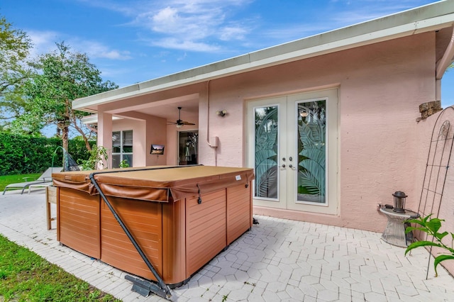 view of patio with french doors and a hot tub