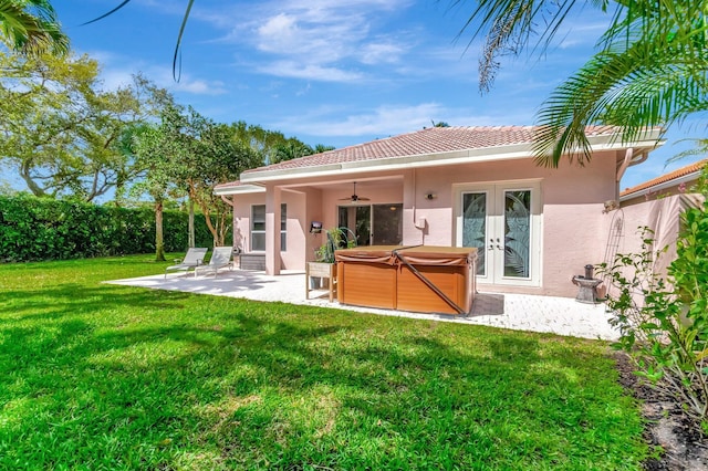 back of house featuring french doors, a patio area, a hot tub, and stucco siding