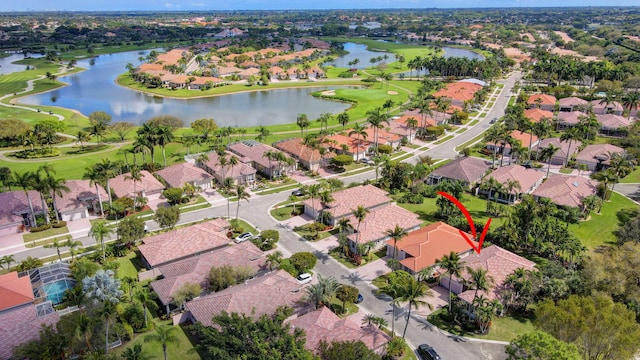 bird's eye view with a residential view, a water view, and golf course view