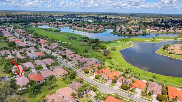 aerial view with a residential view, view of golf course, and a water view