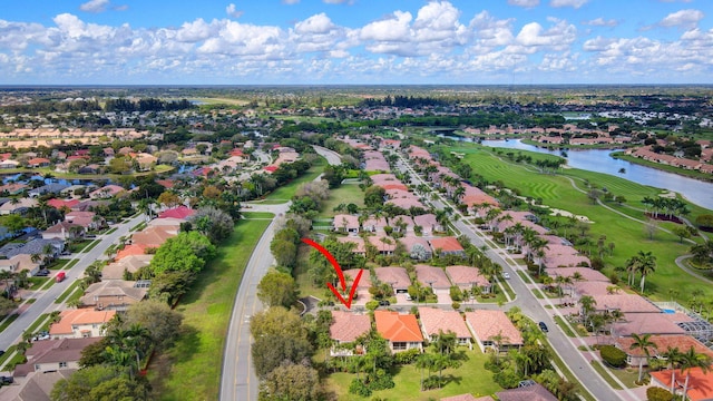 bird's eye view featuring view of golf course, a water view, and a residential view