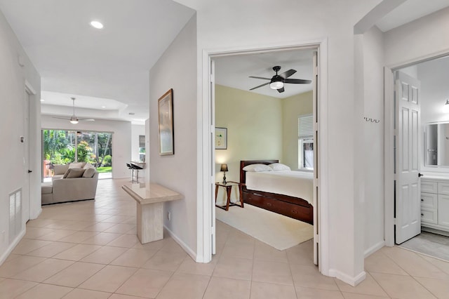 corridor with recessed lighting, light tile patterned flooring, visible vents, and baseboards