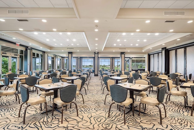 dining space featuring a raised ceiling, visible vents, and light carpet