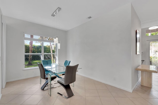 dining room featuring baseboards, visible vents, a wealth of natural light, and light tile patterned flooring