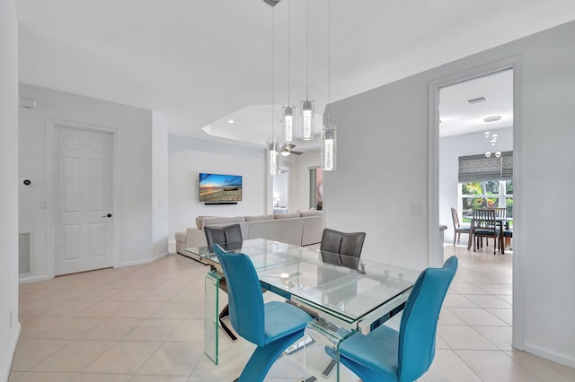 dining area featuring light tile patterned floors, baseboards, and visible vents