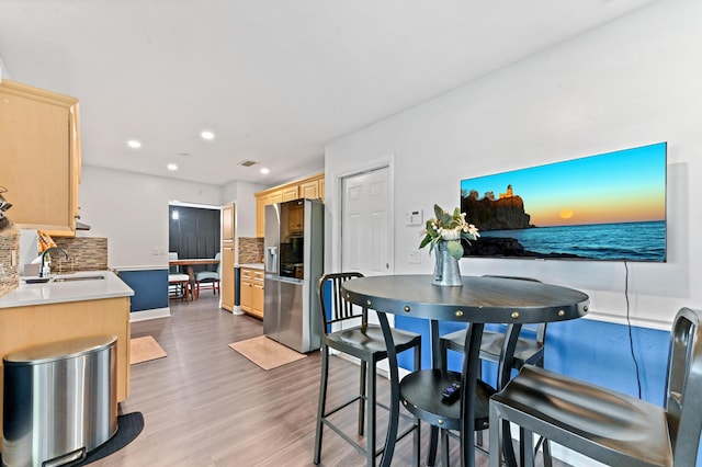 dining space with recessed lighting, visible vents, baseboards, and wood finished floors