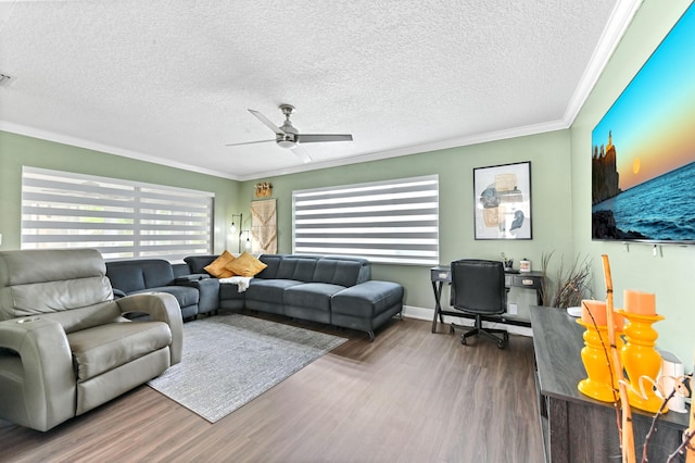 living area featuring a textured ceiling, wood finished floors, visible vents, a ceiling fan, and ornamental molding