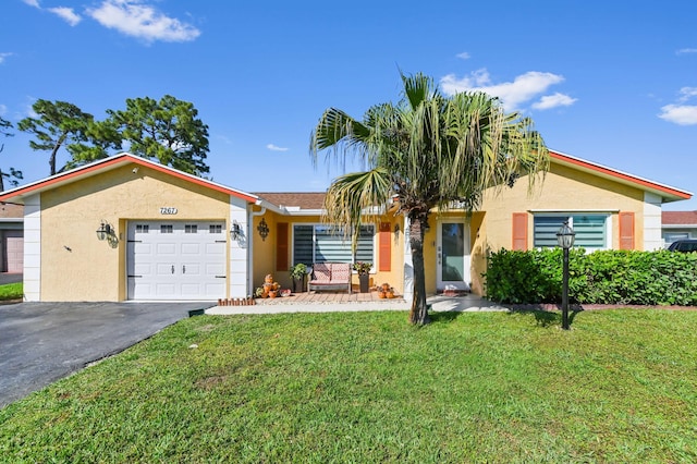 single story home with driveway, a front lawn, an attached garage, and stucco siding