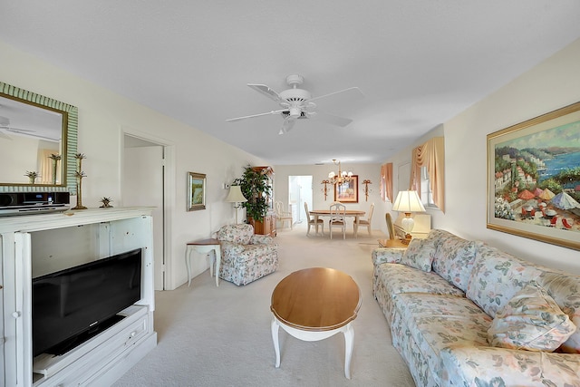 living area with carpet flooring and ceiling fan with notable chandelier