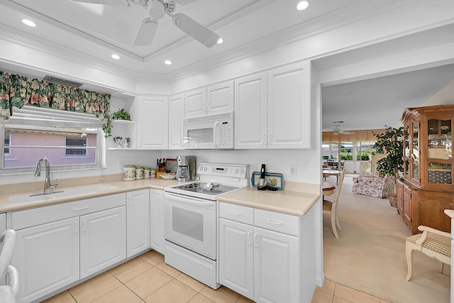 kitchen with a sink, white appliances, white cabinets, light countertops, and ceiling fan