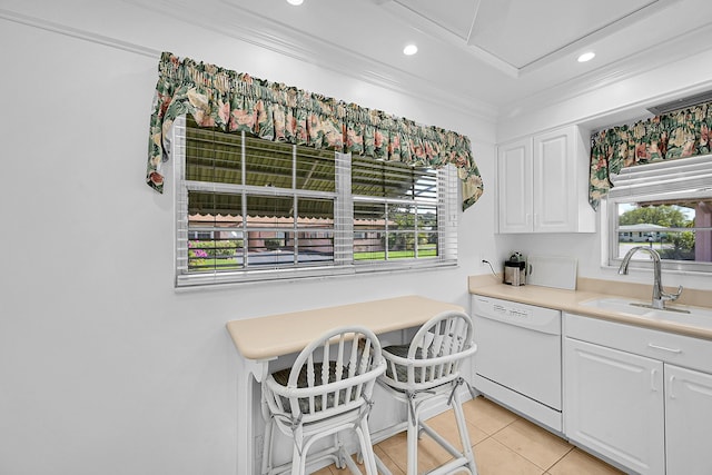 kitchen featuring dishwasher, ornamental molding, light tile patterned floors, white cabinets, and a sink