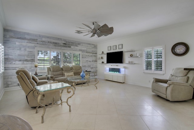 living room featuring baseboards, ornamental molding, a wealth of natural light, and tile patterned floors