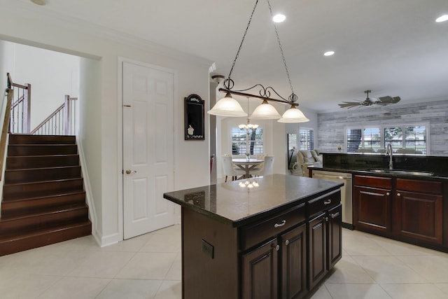 kitchen with a center island, crown molding, recessed lighting, stainless steel dishwasher, and a sink