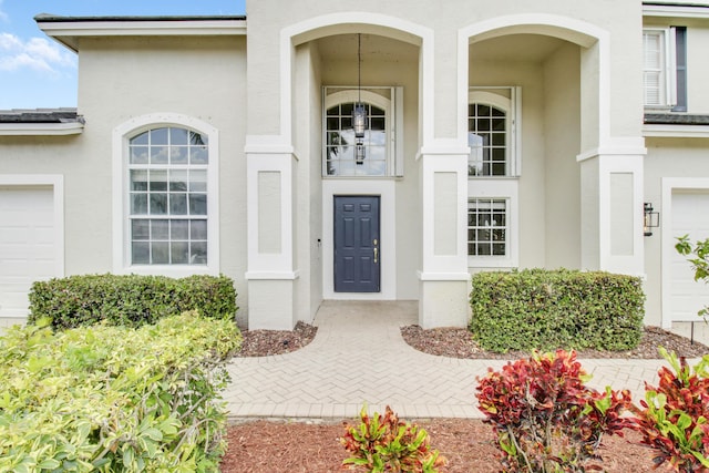 doorway to property featuring stucco siding