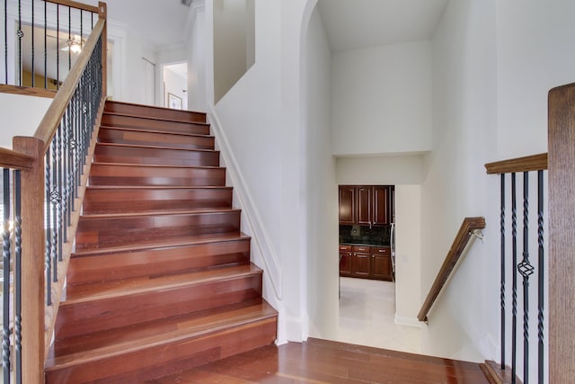 stairs featuring a high ceiling