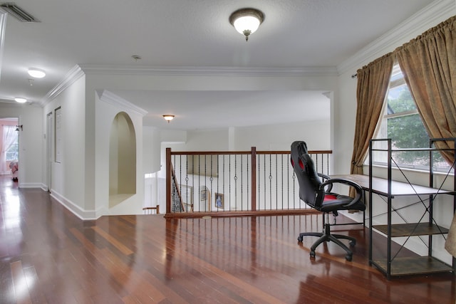 office area featuring baseboards, visible vents, wood finished floors, and ornamental molding