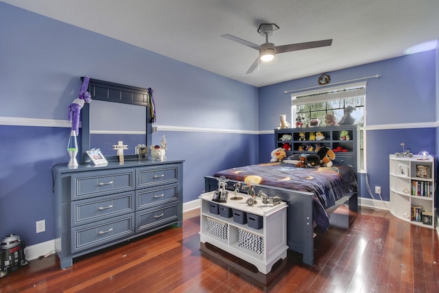 bedroom with ceiling fan, dark wood finished floors, and baseboards