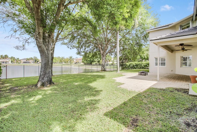 view of yard featuring ceiling fan, a patio area, and a fenced backyard