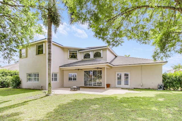 back of house with a yard, french doors, a patio, and ceiling fan