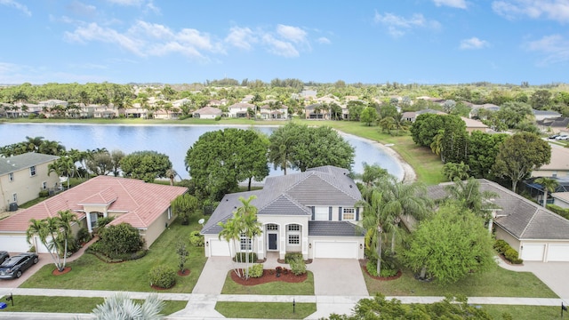 drone / aerial view featuring a water view and a residential view