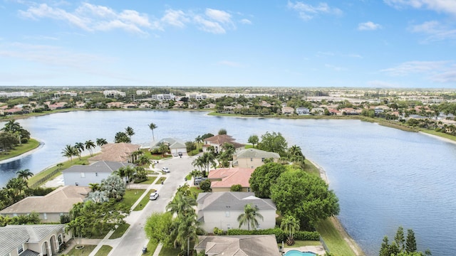 drone / aerial view with a residential view and a water view