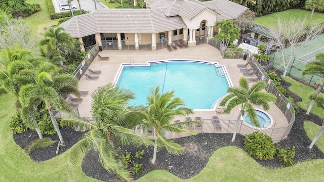 community pool featuring a patio and fence