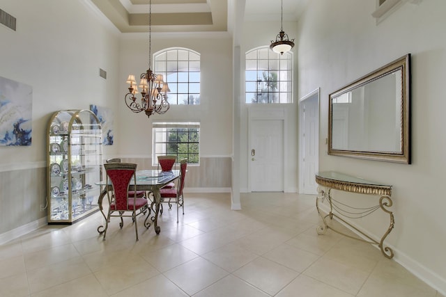 dining area featuring ornamental molding, wainscoting, a notable chandelier, and visible vents