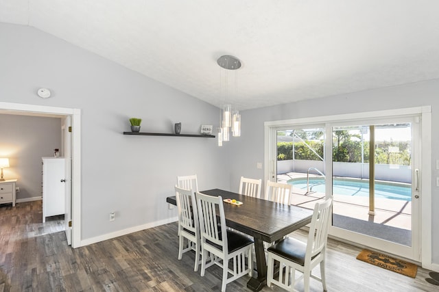 dining area with baseboards, lofted ceiling, and wood finished floors