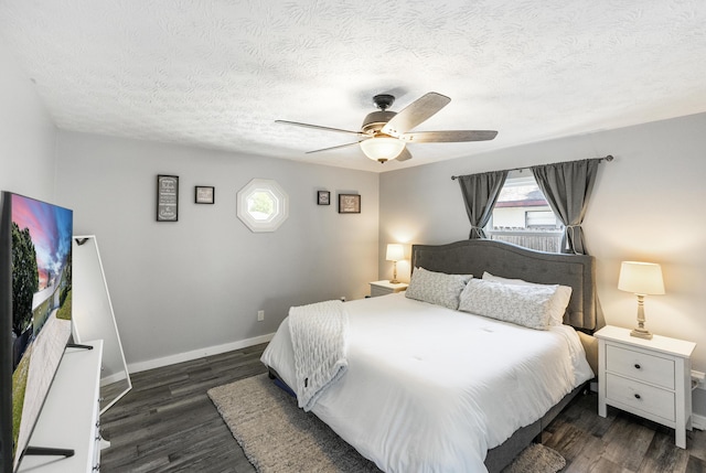 bedroom with a textured ceiling, a ceiling fan, baseboards, and wood finished floors