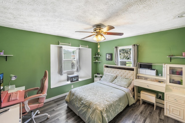 bedroom featuring multiple windows, ceiling fan, baseboards, and wood finished floors