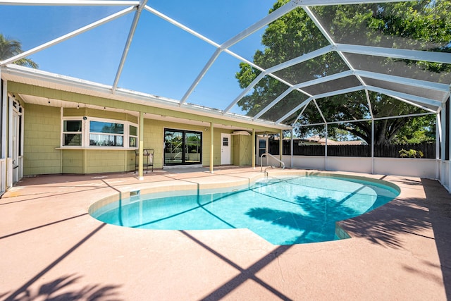 view of pool featuring a fenced in pool, glass enclosure, a patio, and fence