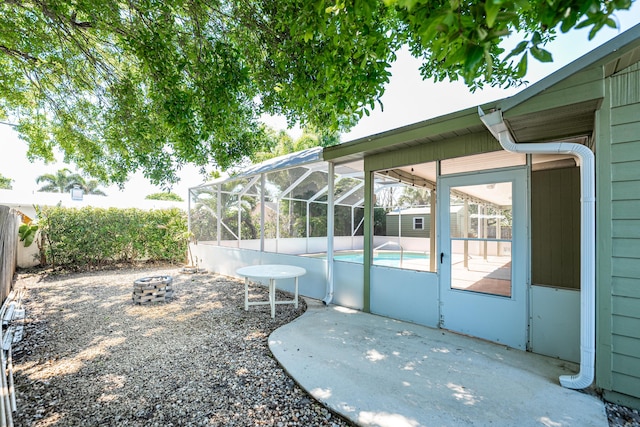 view of yard featuring a fenced in pool, fence, a lanai, an outdoor fire pit, and a patio