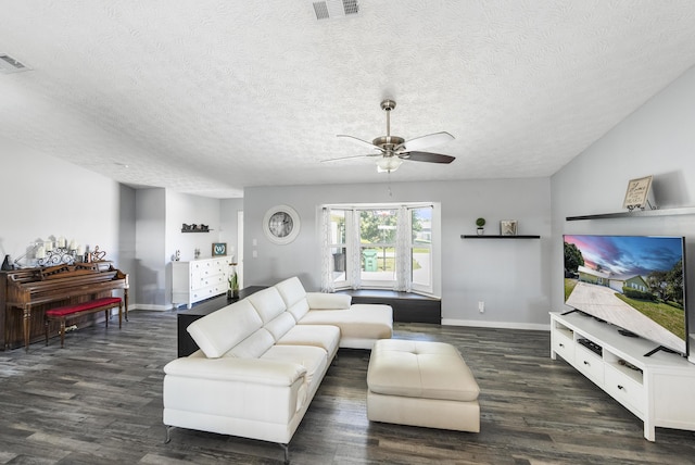 living room with visible vents, baseboards, ceiling fan, and dark wood-style flooring