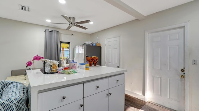 kitchen featuring visible vents, a ceiling fan, white cabinets, light countertops, and freestanding refrigerator