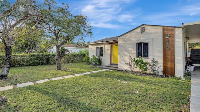 view of front of property with a front lawn and stucco siding