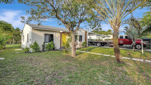 view of front of property featuring a front yard and stucco siding